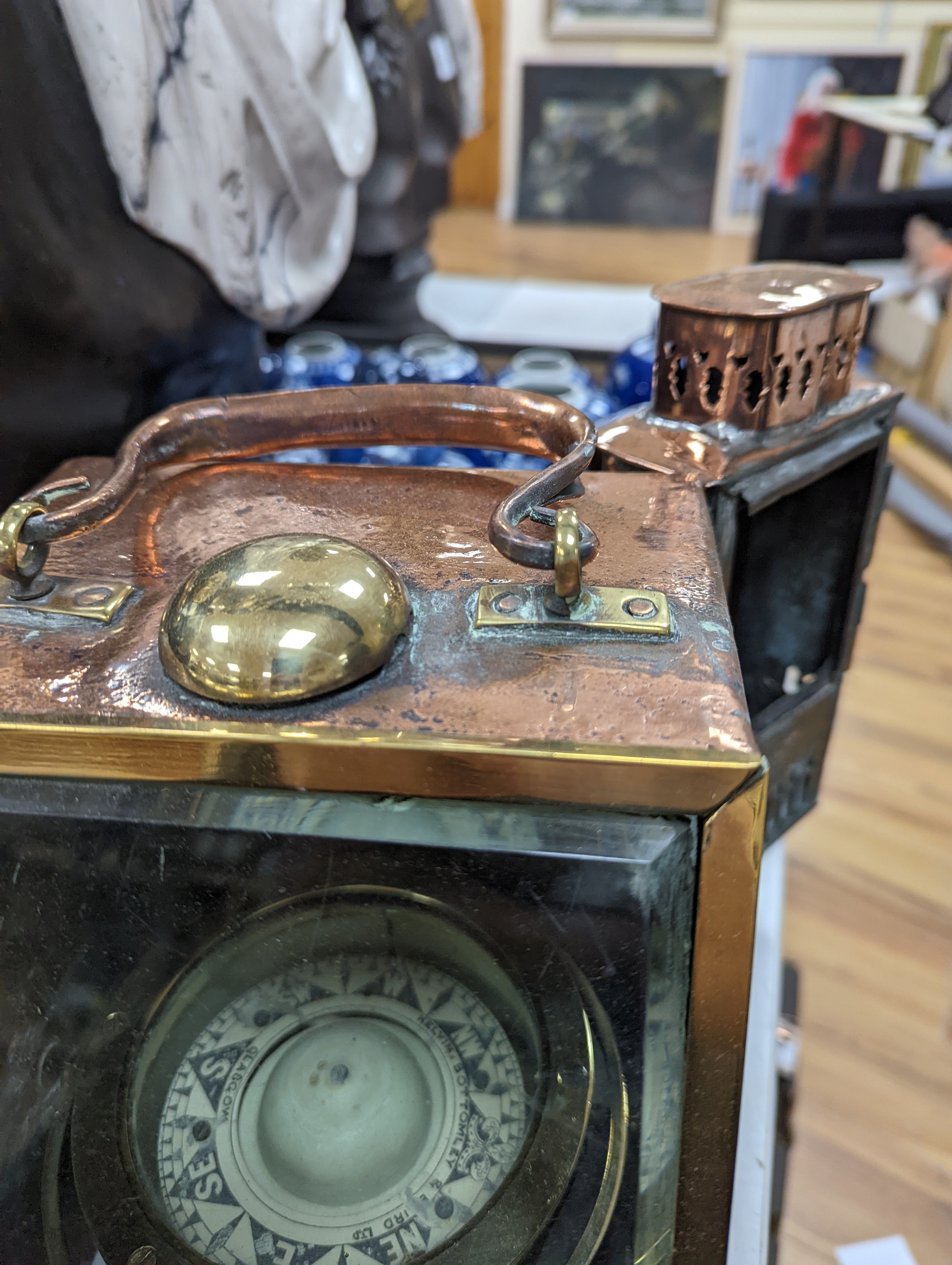 A copper ship's binnacle compass, a brass oil lamp, a brass jug and a copper kettle